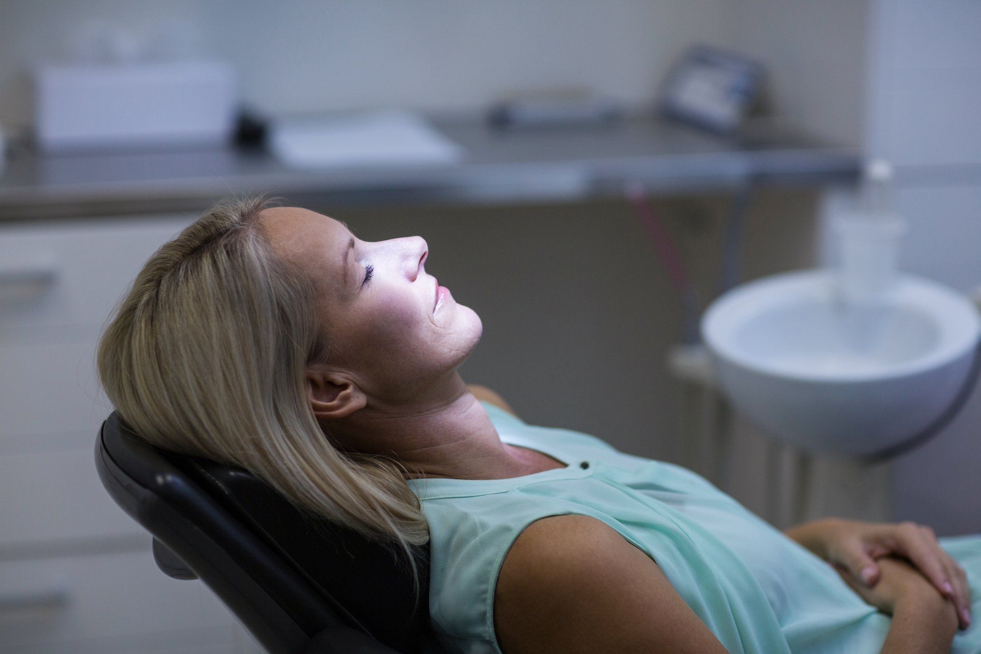 A relaxed patient resting comfortably in the dental chair during sedation